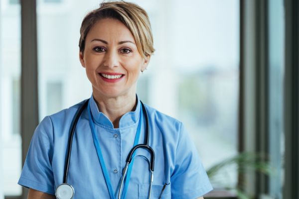 portrait-smiling-nurse-looking-camera-while-standing-clinic.jpg